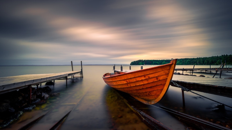 Orange boat docked at a pier in Sweden