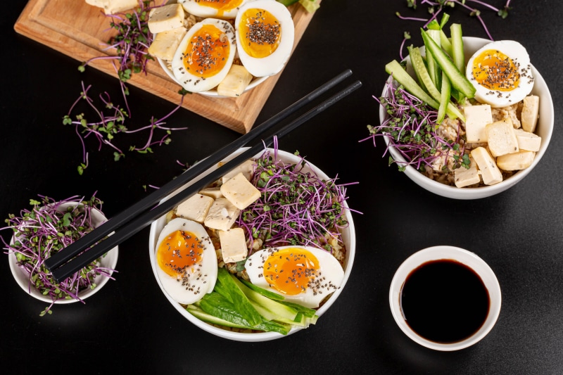 Buddha bowls with eggs, tofu, and sprouts