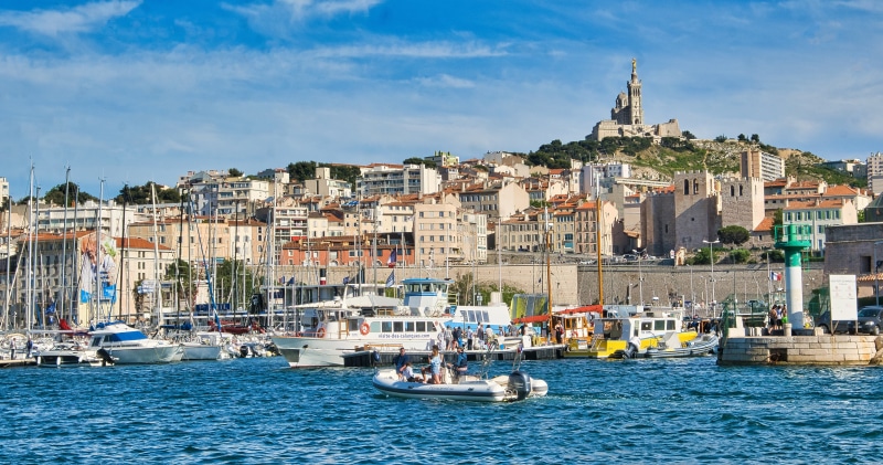 Boats in Marseille Harbor with Notre-Dame de la Garde