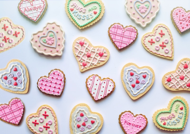 Many heart-shaped Valentine's Day cookies with lettering