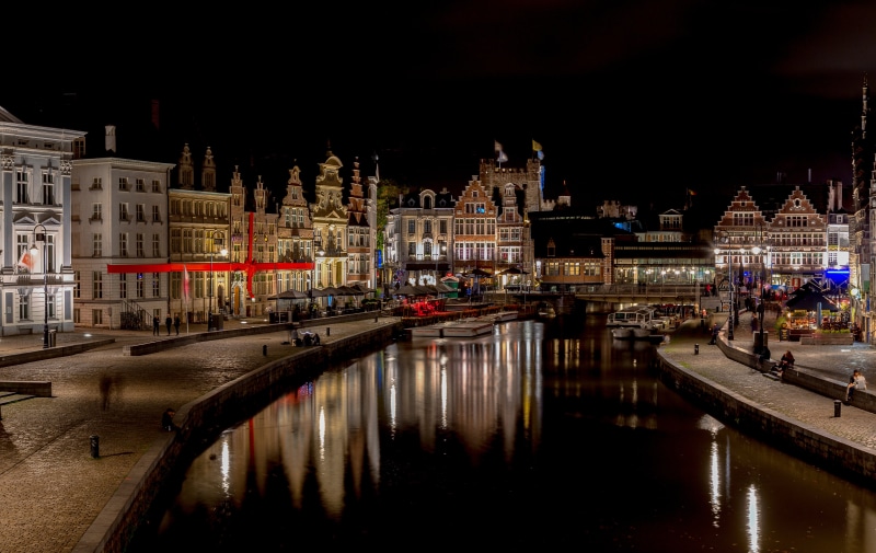 Ghent canal waterfront at night with illuminated buildings
