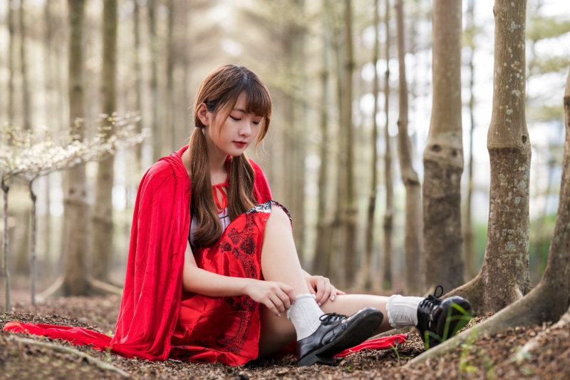 4K Asian girl in Red Riding Hood costume in forest