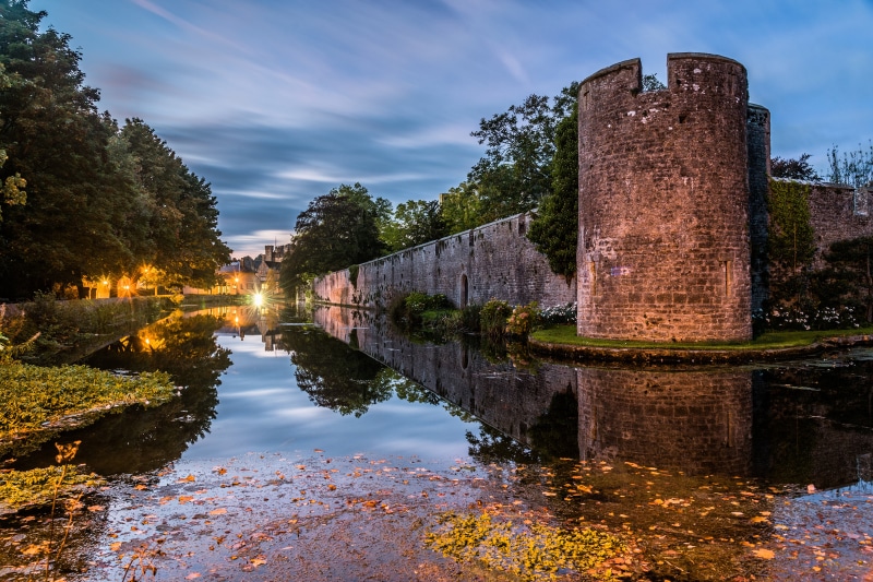 Wells England Palace Tower and Pond at Dusk
