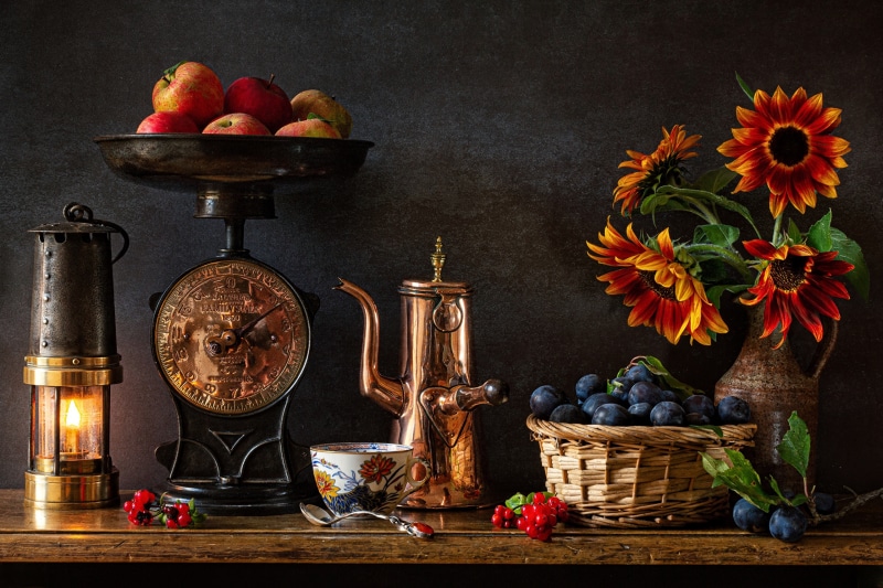 Still-life with apples, plums, sunflowers, and kerosene lamp