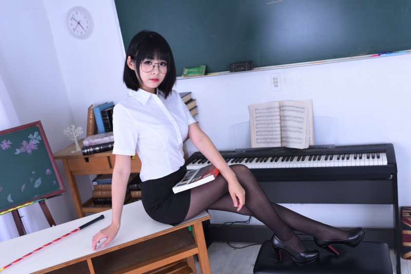 Asian Brunette Girl in Glasses Sitting with Book