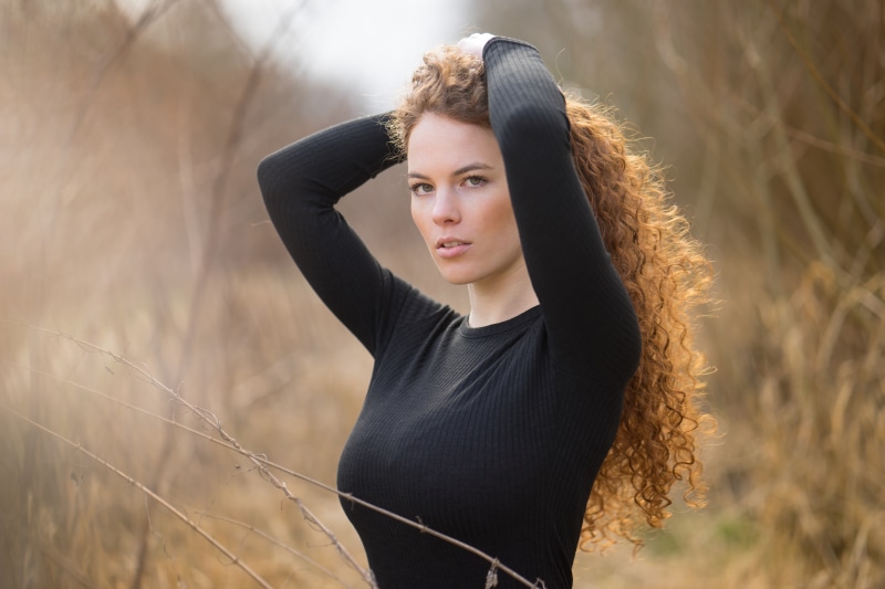 Katja with curly hair in black top