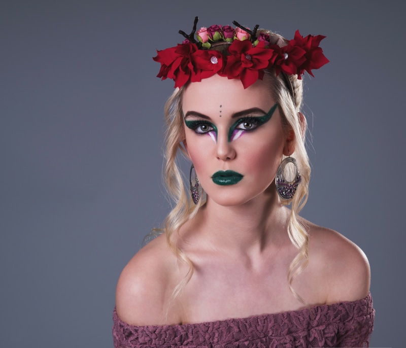 Blonde girl with flower wreath and green makeup