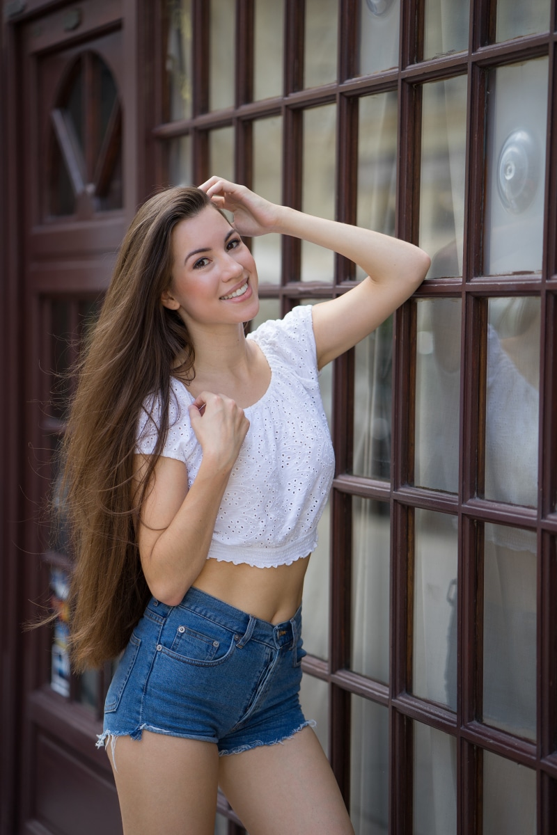 Julia with long brown hair wearing shorts