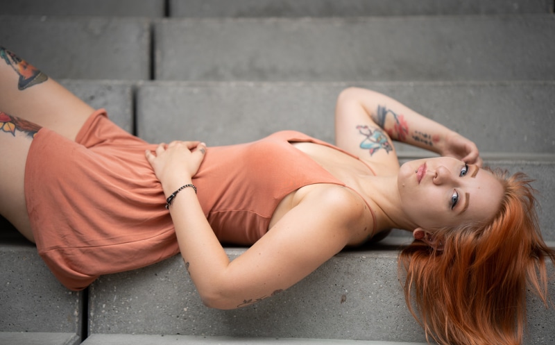 Karolina Redhead girl lying down with tattoos