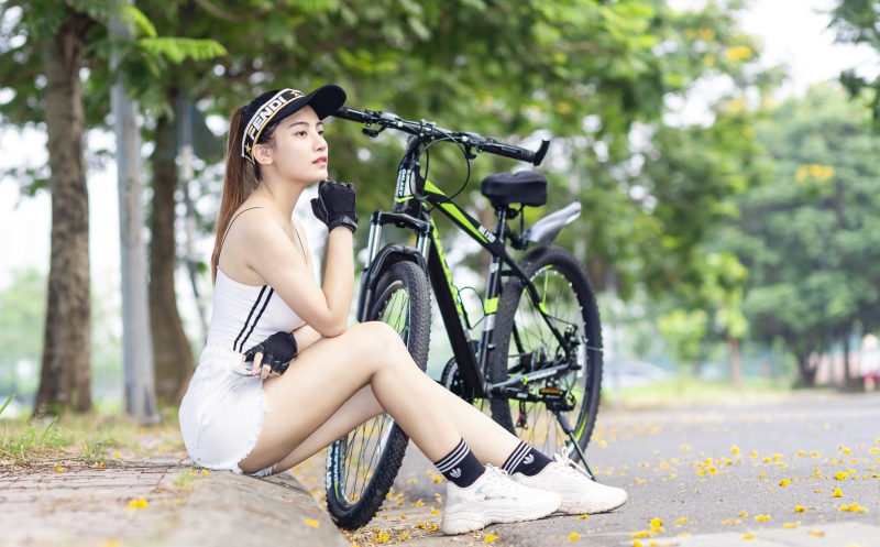 Asian woman in Fendi cap with bicycle
