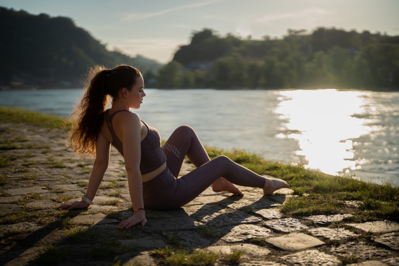 Katja sitting by the water at sunset