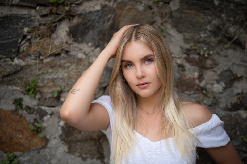 Carina with blonde hair and tattoo