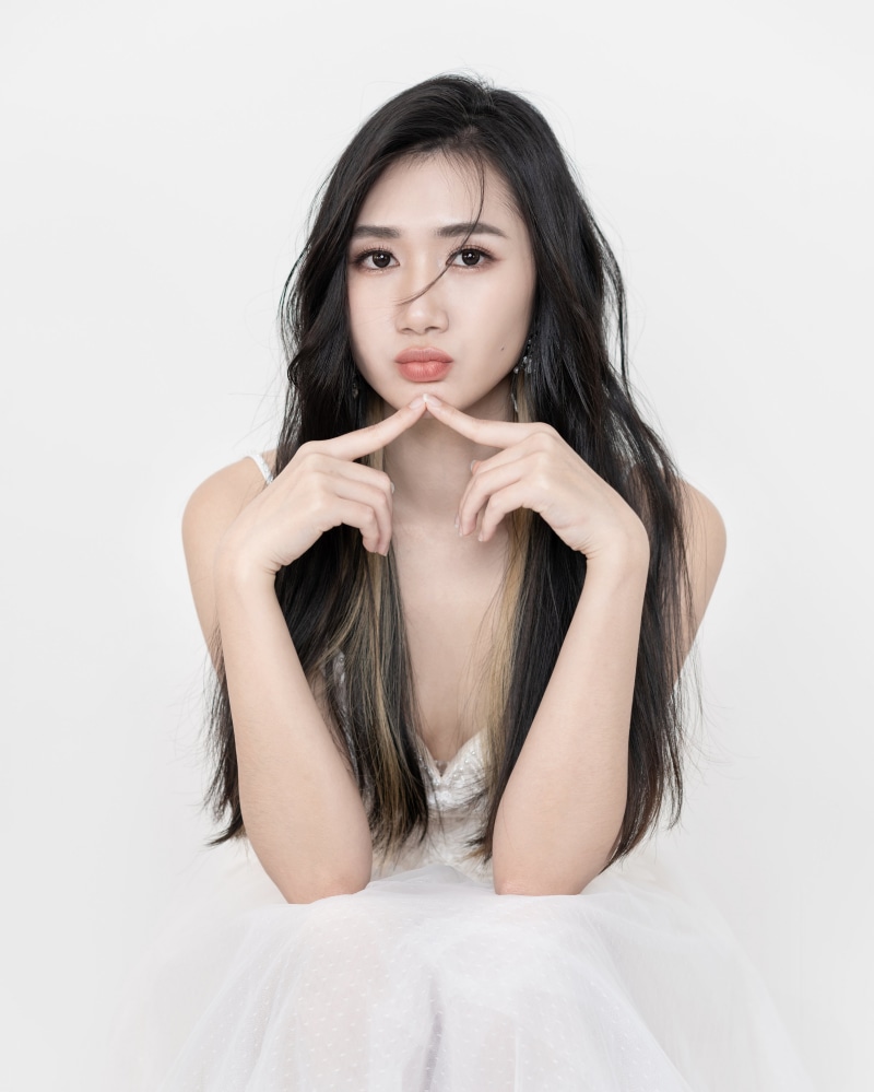 Brunette girl with fingers near face