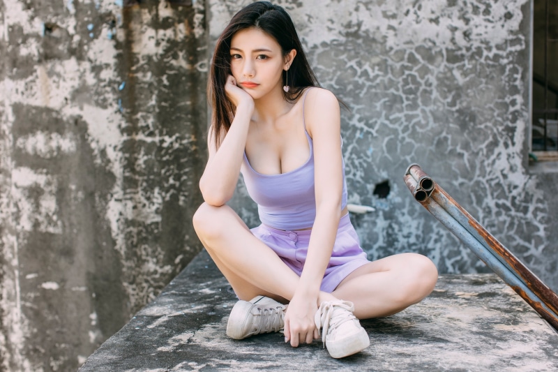 Asian woman sitting and posing