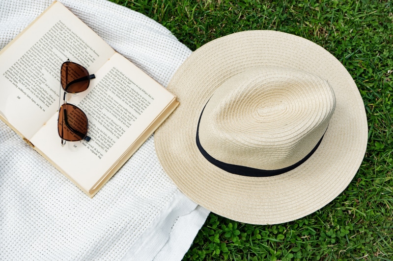Book, Sunglasses, and Hat on Grass