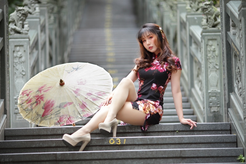 Asian Model in Cheongsam with Umbrella on Stairs