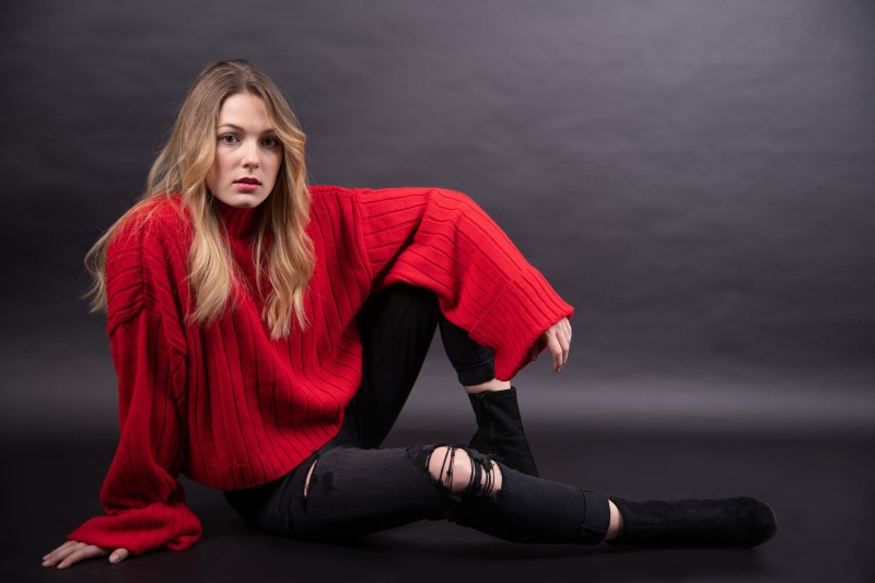 Claudie Michaud-Couture in red sweater and ripped jeans