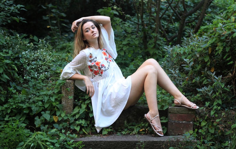 Lizzy sitting in a garden
