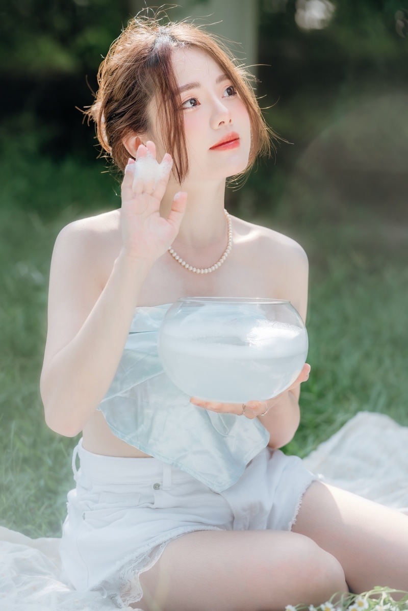 Asian woman with brown hair holding a glass bowl