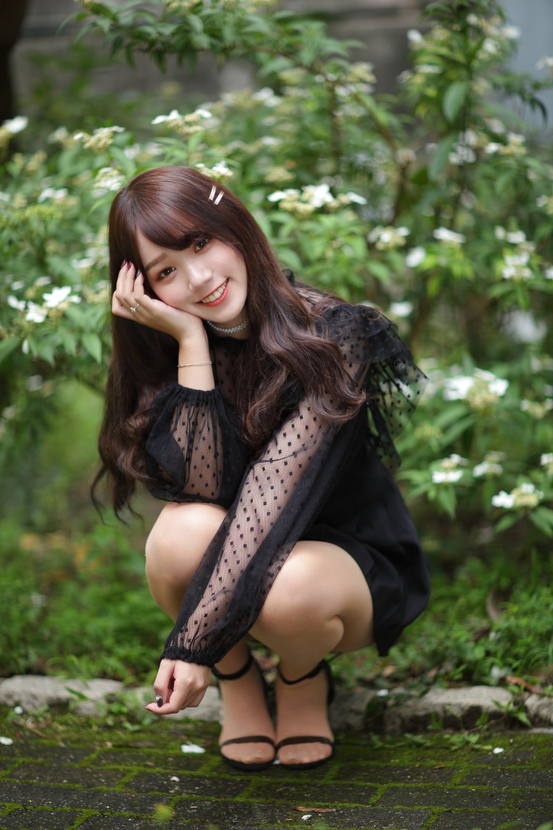 Asian woman with brown hair posing outdoors