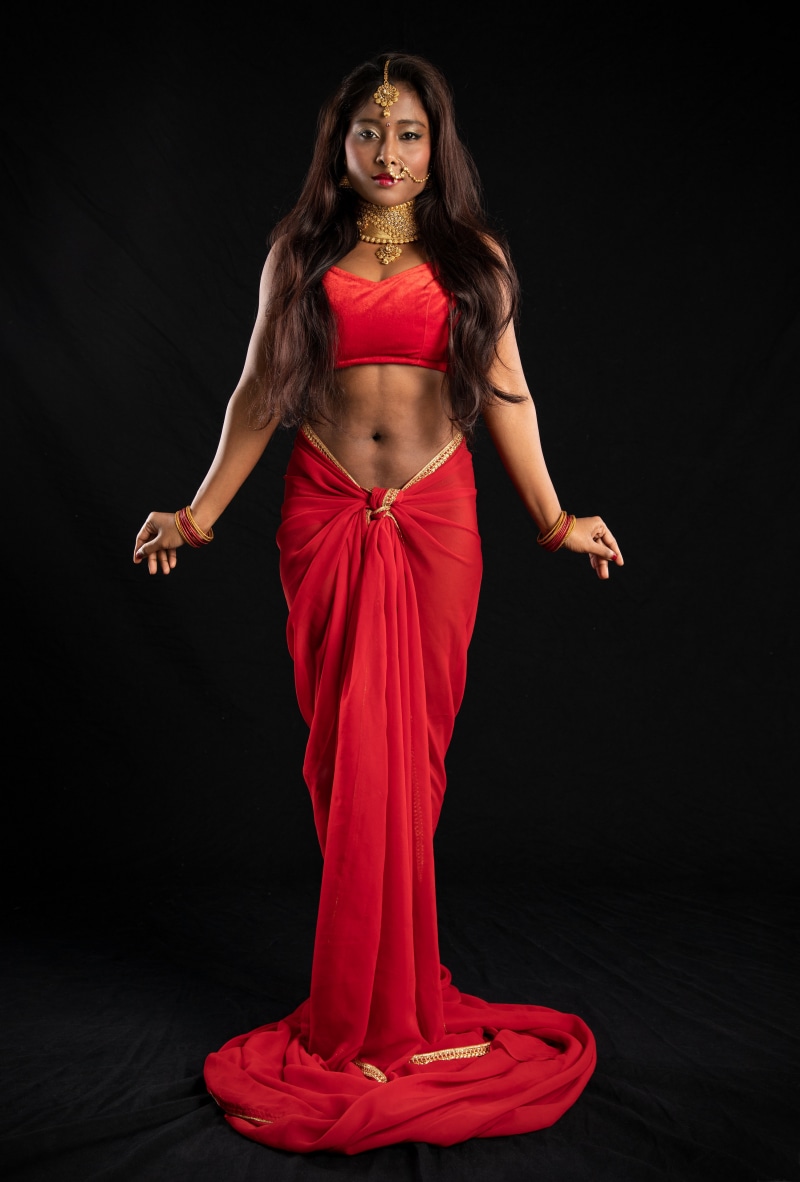 Woman in red sari with gold jewelry