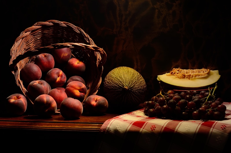 Peaches, Grapes, and Melons in a Wicker Basket