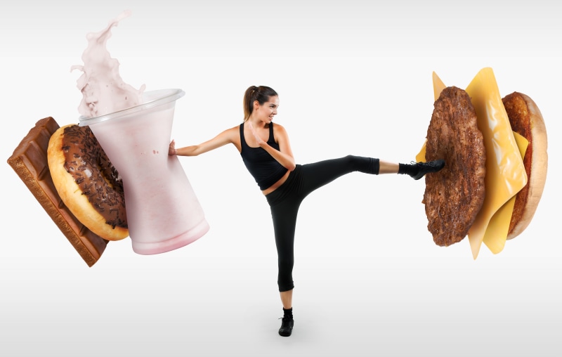 Woman kicking fast food and sweets