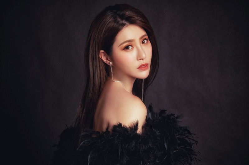 Asian woman with brown hair and earrings