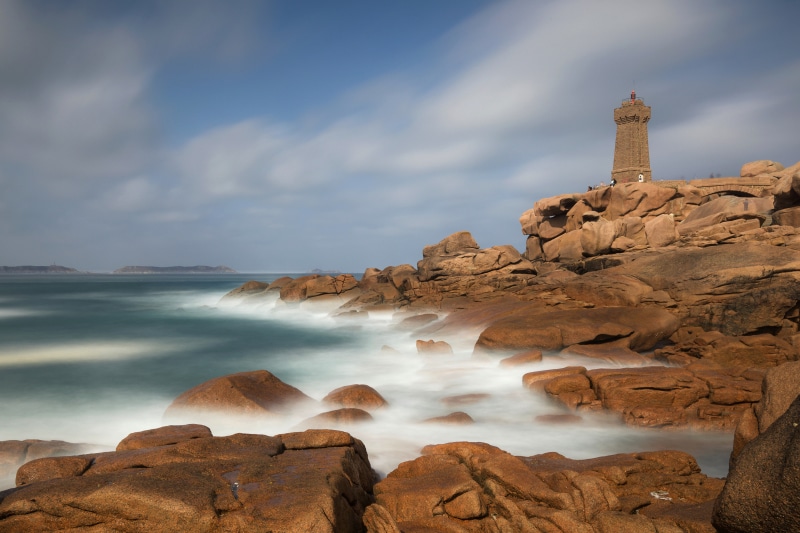 Lighthouse on rocky coast in Brittany, France