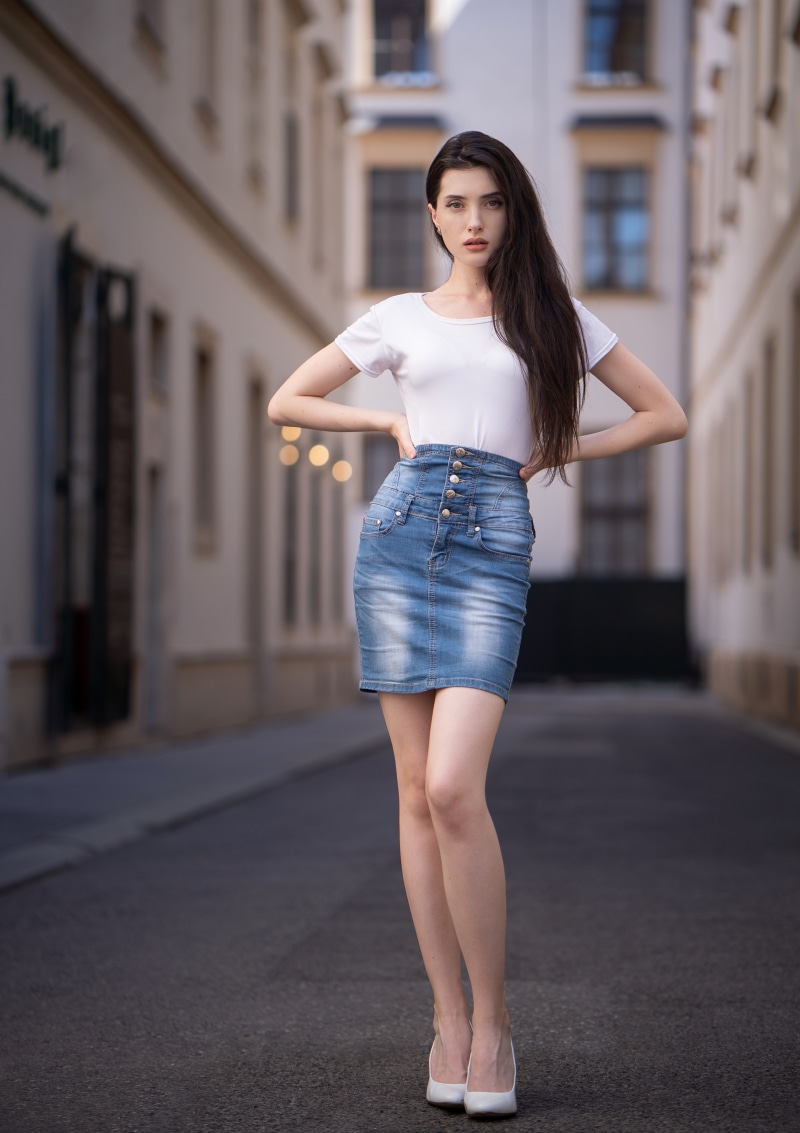 Anastasia in a white t-shirt and denim skirt