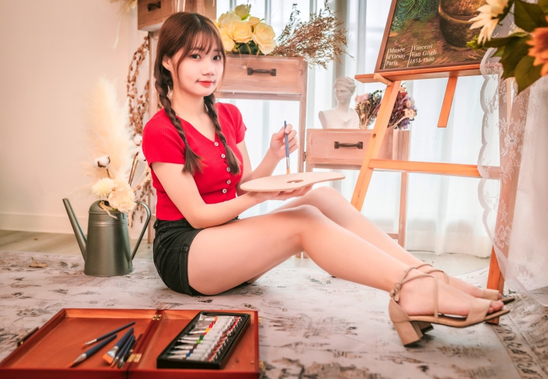 Asian woman with braid hair painting