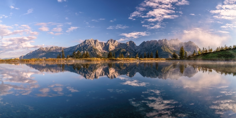Kaisergebirge Mountains reflected in a lake in Austria
