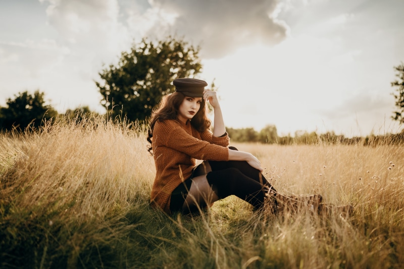 Virginia Hinz in a sweater and baseball cap in a field
