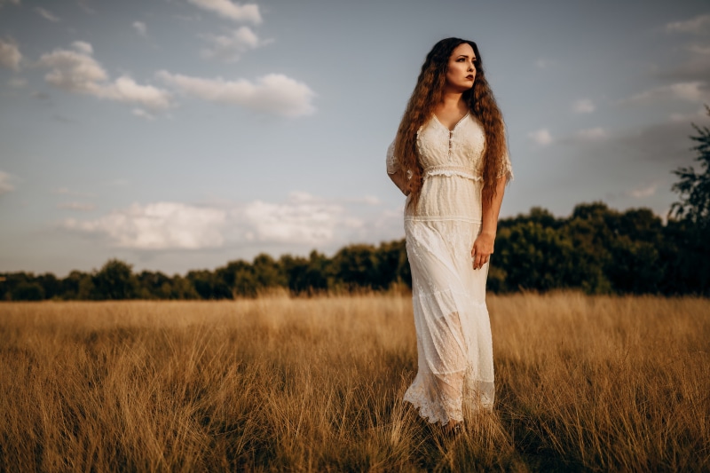 Model Virginia Hinz in a white dress in a field