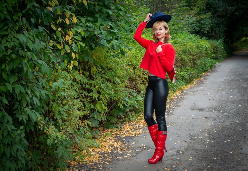 Woman in red top and black leggings with blue hat