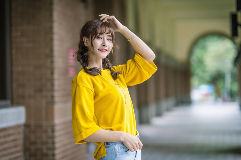 Asian woman with pigtails smiling