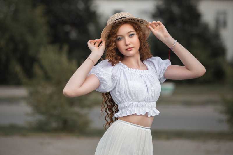 Angelina Tikhonova wearing a hat and white top
