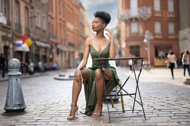 Woman in green dress sitting at a table