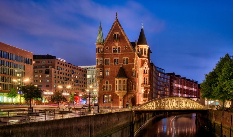 Hamburg waterfront with historic building and bridge at night