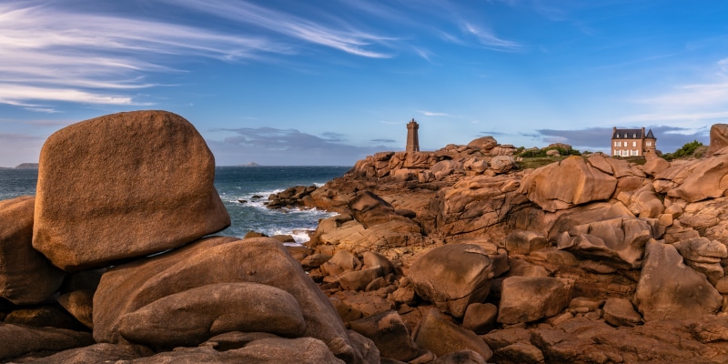 Coastline with lighthouse and house in Brittany, France