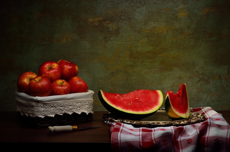 Still-life of apples and watermelon slices with a knife
