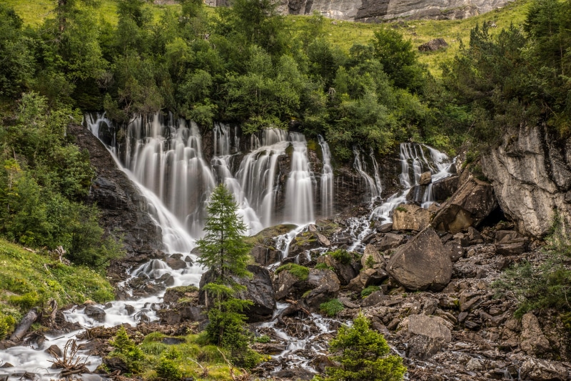 Switzerland Alps Waterfall with Rocks and Trees