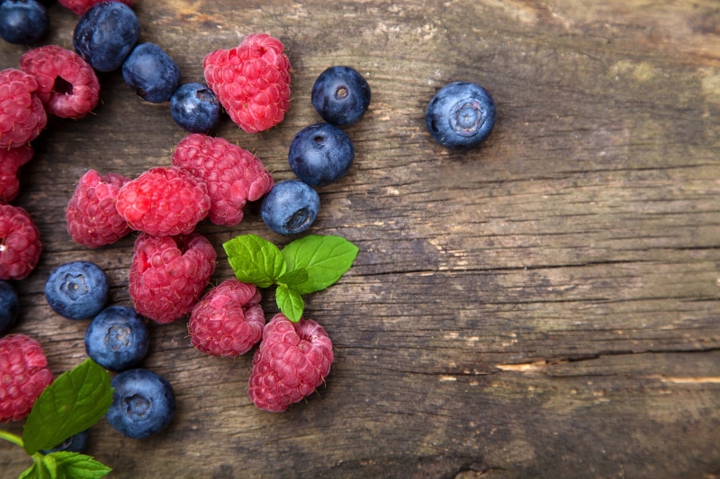 Raspberries and Blueberries on Wood Planks