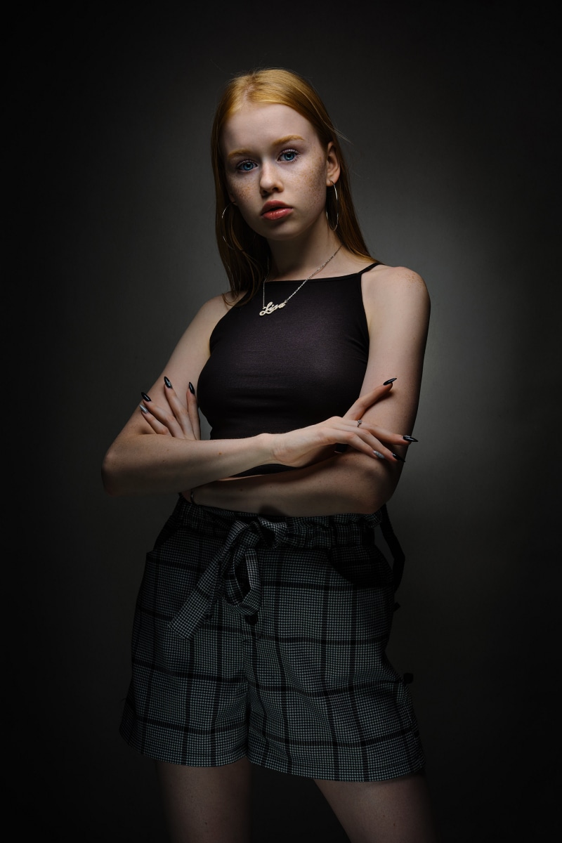 Redhead girl Lisa posing with arms crossed