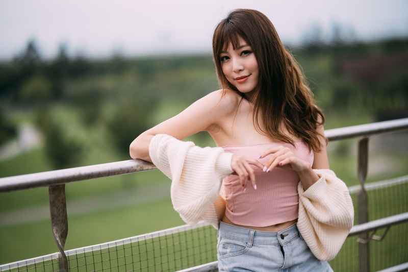 Asian woman in pink tube top and jeans