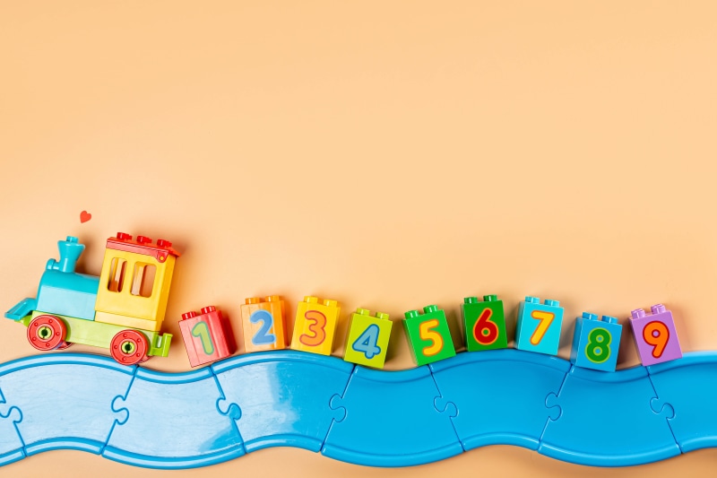 Toy train with numbered blocks on puzzle track
