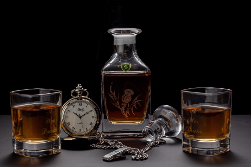 Whisky bottle and glasses with pocket watch