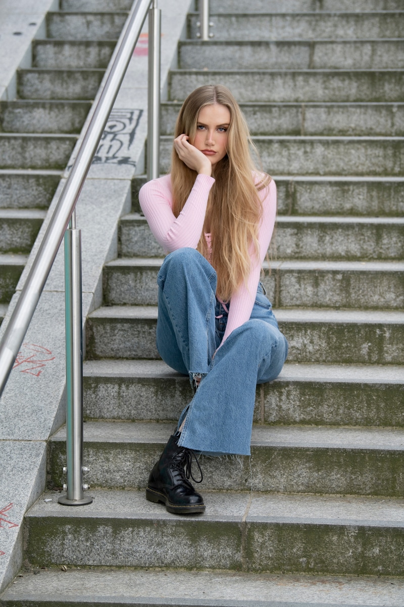 Blonde girl sitting on stairs