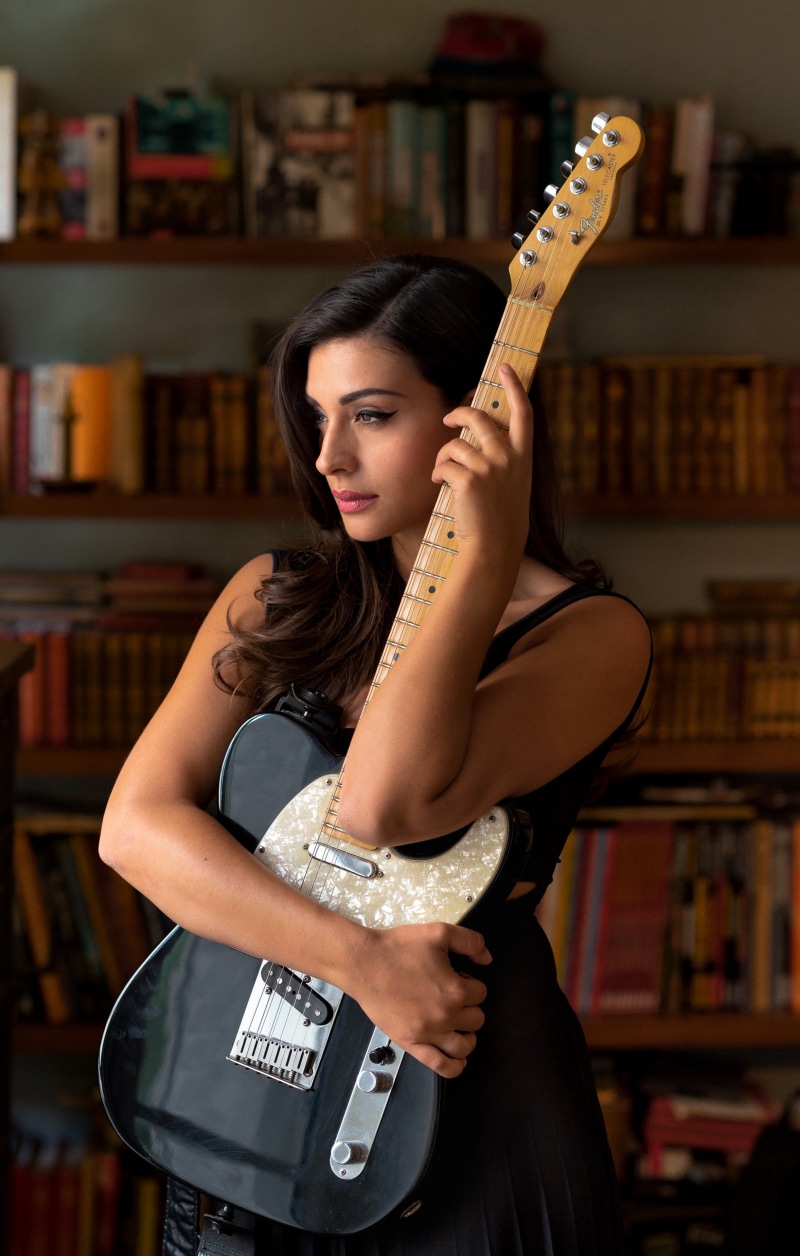 Tess Perrone holding a Fender Telecaster guitar