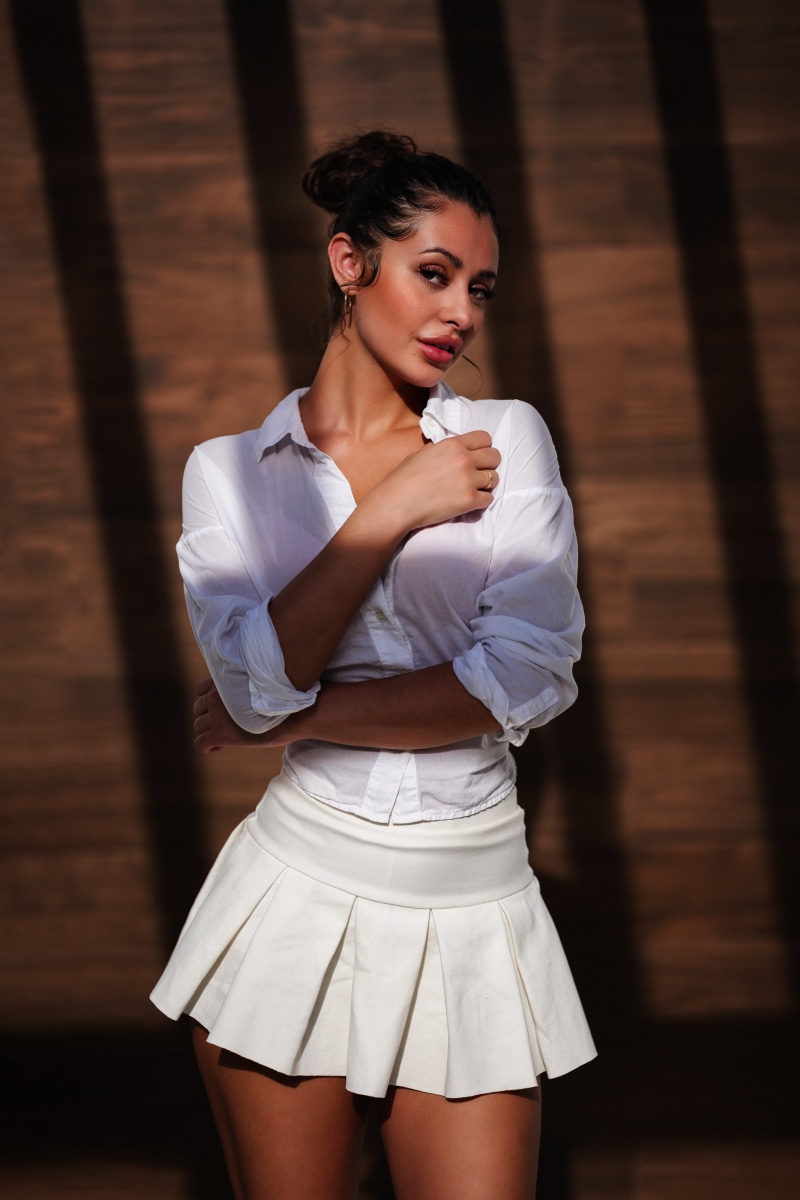 Amanda in a white blouse and skirt